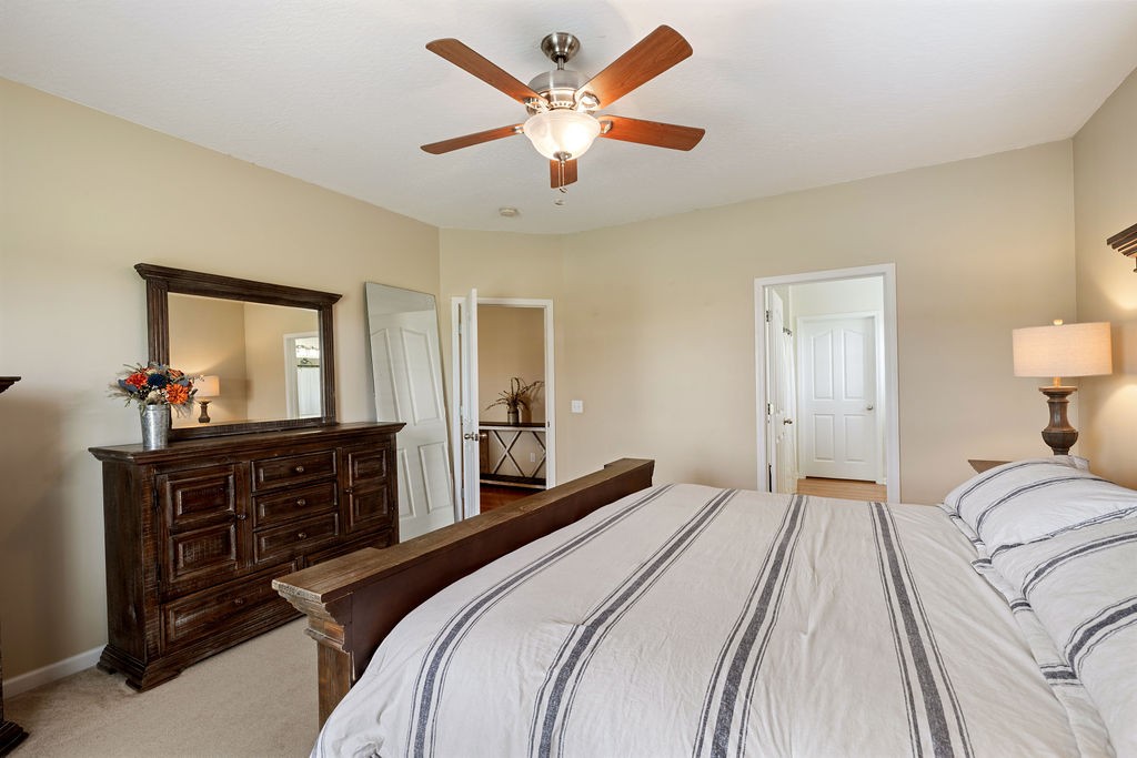 137 Piney Road Lawrenceburg, TN 38464 - Photo 17 of 33 a bedroom with a bed and a chandelier