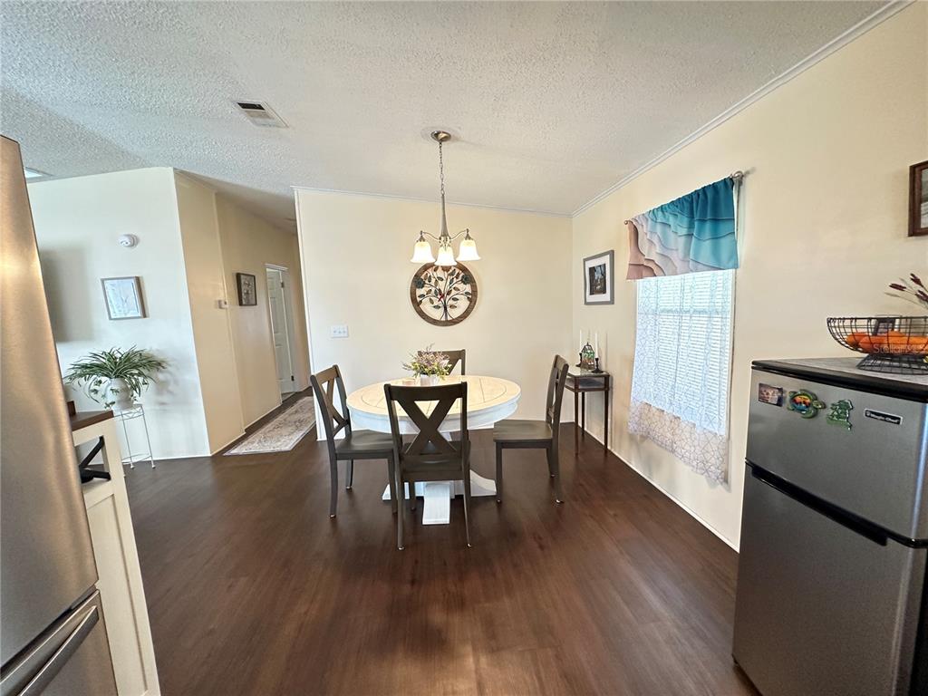 16735 Olivaud Street Hudson, FL 34667 - Photo 11 of 53 a view of a dining room with furniture window and wooden floor