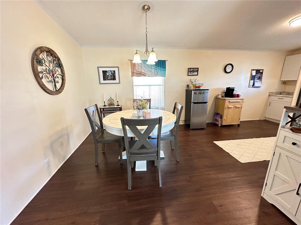 16735 Olivaud Street Hudson, FL 34667 - Photo 12 of 53 a view of a dining room with furniture and wooden floor
