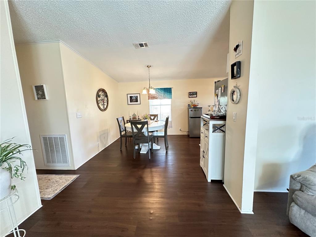 16735 Olivaud Street Hudson, FL 34667 - Photo 14 of 53 a view of a dining room with furniture and wooden floor