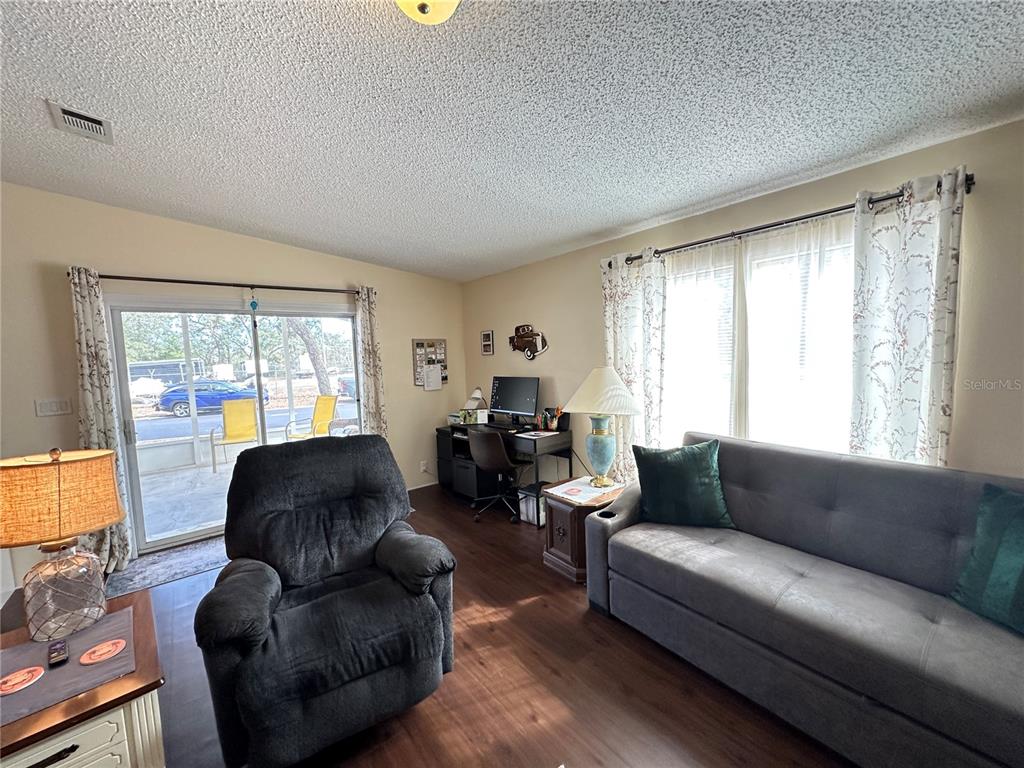 16735 Olivaud Street Hudson, FL 34667 - Photo 15 of 53 a living room with furniture and a large window