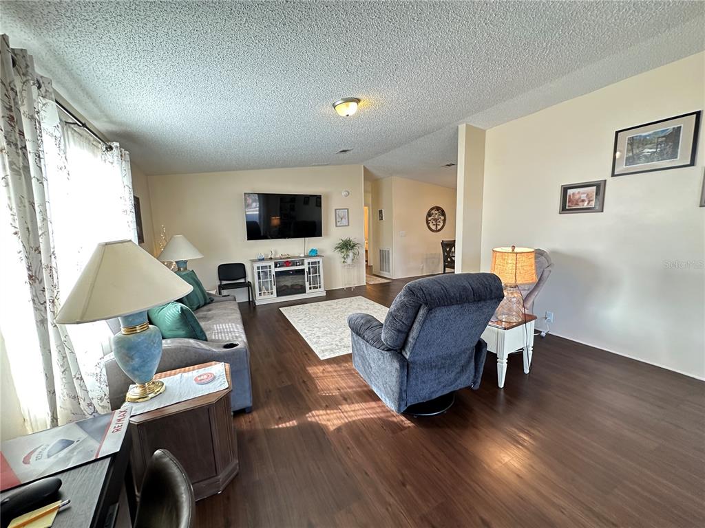 16735 Olivaud Street Hudson, FL 34667 - Photo 17 of 53 a living room with furniture and a flat screen tv