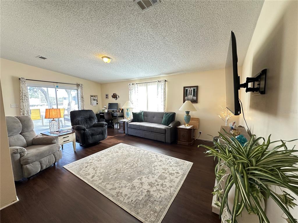 16735 Olivaud Street Hudson, FL 34667 - Photo 19 of 53 a living room with furniture and a rug