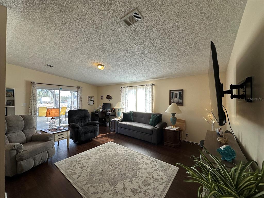 16735 Olivaud Street Hudson, FL 34667 - Photo 20 of 53 a living room with furniture and a flat screen tv