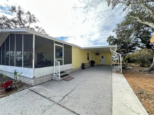 a view of a house with backyard and porch