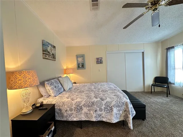 a bedroom with a bed and a chair