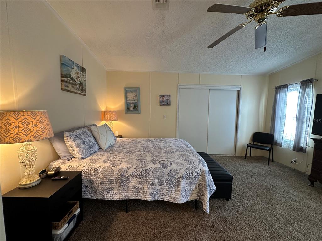 16735 Olivaud Street Hudson, FL 34667 - Photo 35 of 53 a bedroom with a bed and a chair