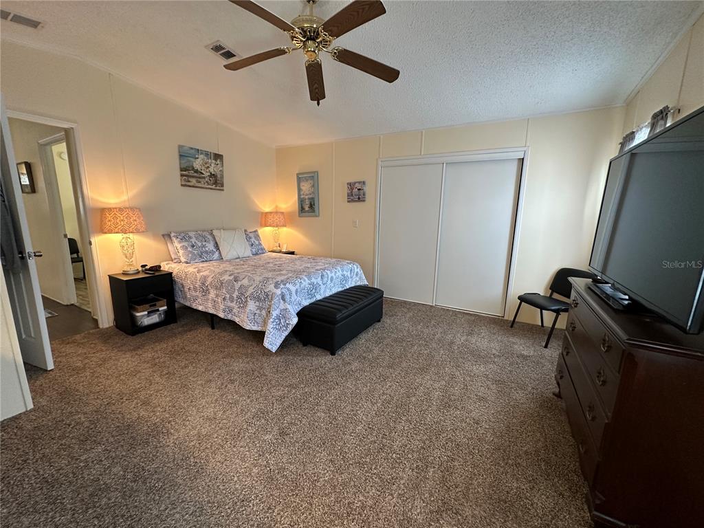 16735 Olivaud Street Hudson, FL 34667 - Photo 40 of 53 a spacious bedroom with a bed and a walk in closet