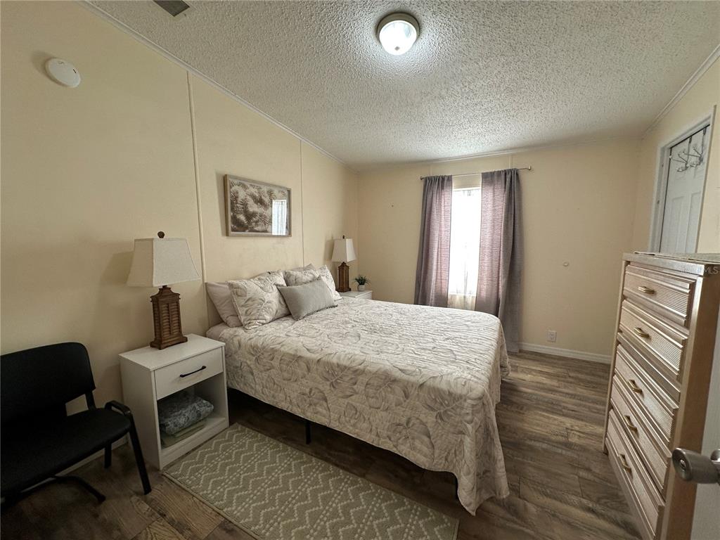 16735 Olivaud Street Hudson, FL 34667 - Photo 41 of 53 a bedroom with a bed and wooden floor