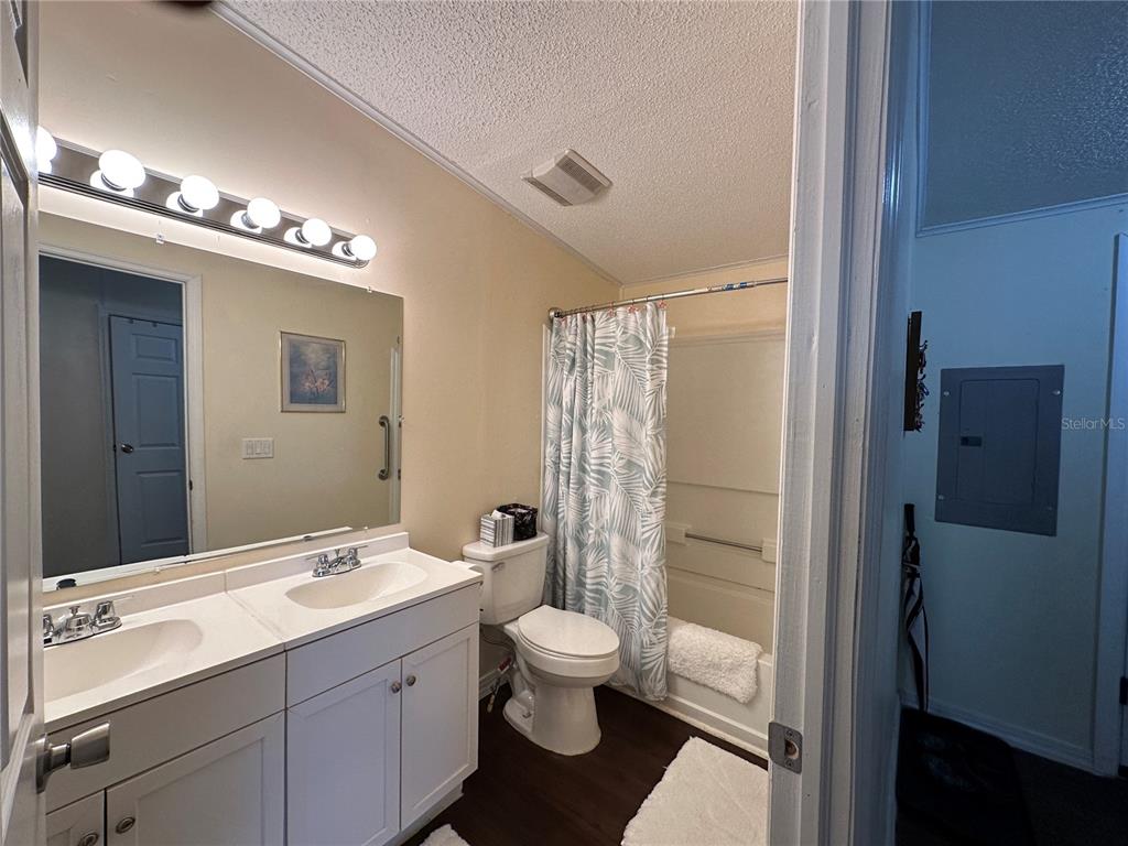 16735 Olivaud Street Hudson, FL 34667 - Photo 45 of 53 a bathroom with a double vanity sink toilet mirror and shower
