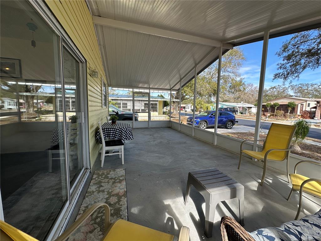 16735 Olivaud Street Hudson, FL 34667 - Photo 46 of 53 a living room with lots of furniture and a floor to ceiling window