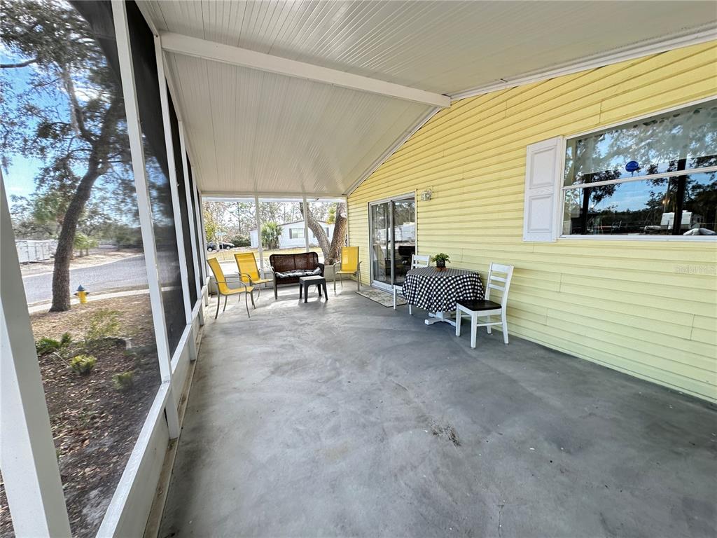 16735 Olivaud Street Hudson, FL 34667 - Photo 51 of 53 a view of a porch with chairs and floor to ceiling window