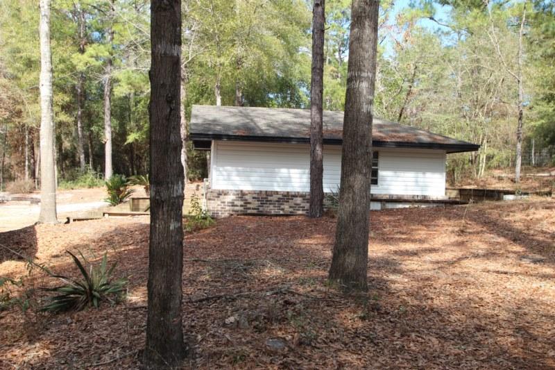 6019 Gagnon Road Crestview, FL 32539 - Photo 12 of 36 a view of a entrance gate of the house and trees