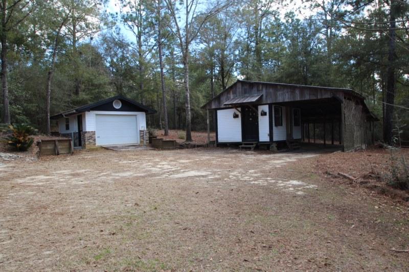 6019 Gagnon Road Crestview, FL 32539 - Photo 17 of 36 a view of a house with a yard and large tree