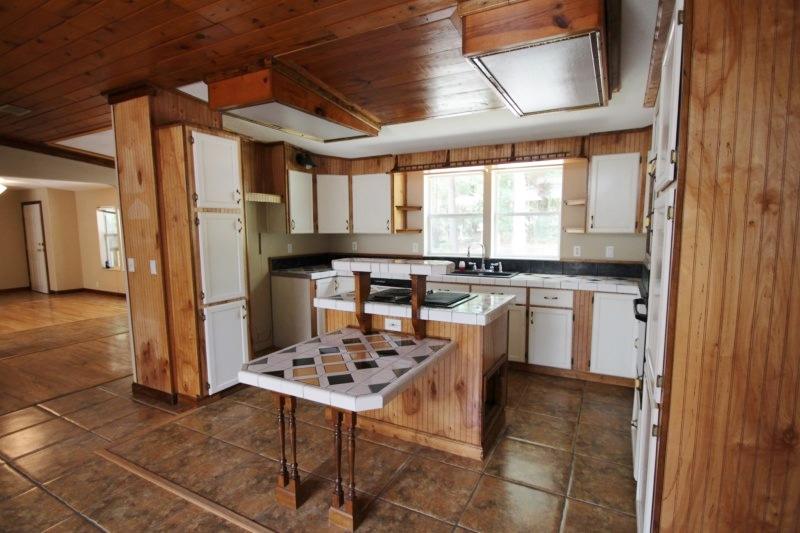 6019 Gagnon Road Crestview, FL 32539 - Photo 3 of 36 a kitchen with a sink a stove a refrigerator and cabinets