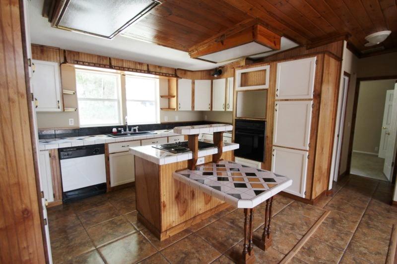 6019 Gagnon Road Crestview, FL 32539 - Photo 24 of 36 a kitchen with stainless steel appliances kitchen island granite countertop a sink stove and refrigerator
