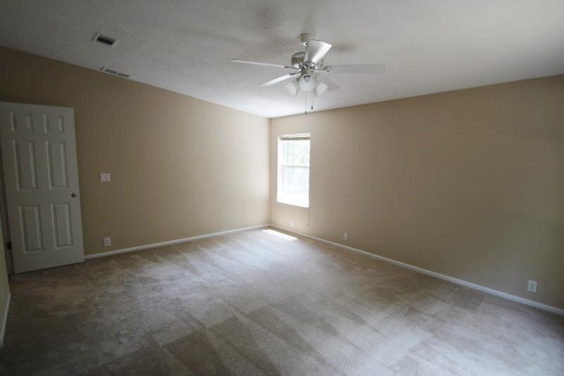 6019 Gagnon Road Crestview, FL 32539 - Photo 28 of 36 an empty room with windows and chandelier fan
