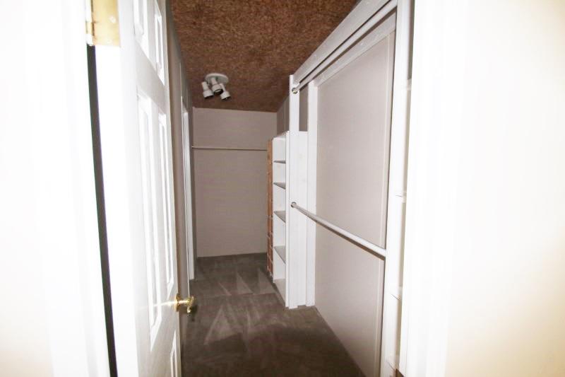 6019 Gagnon Road Crestview, FL 32539 - Photo 29 of 36 a view of a hallway with white walls and refrigerator