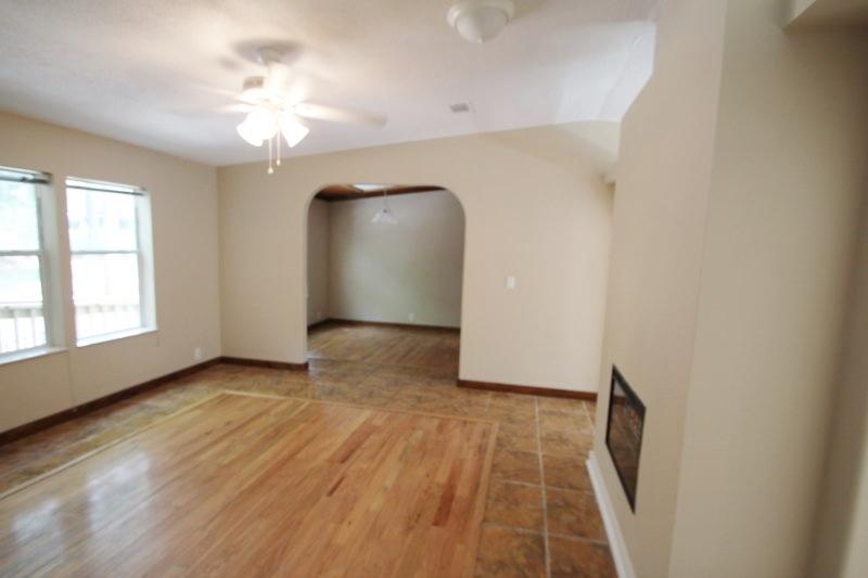 6019 Gagnon Road Crestview, FL 32539 - Photo 5 of 36 an empty room with wooden floor and windows