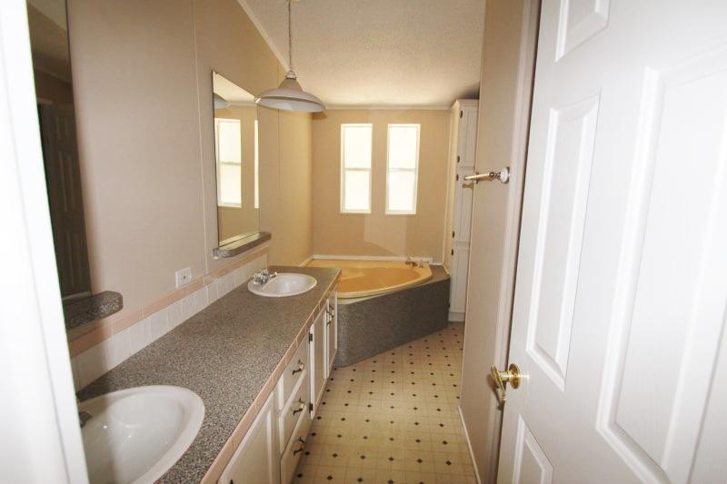 6019 Gagnon Road Crestview, FL 32539 - Photo 7 of 36 a bathroom with a granite countertop sink toilet and shower