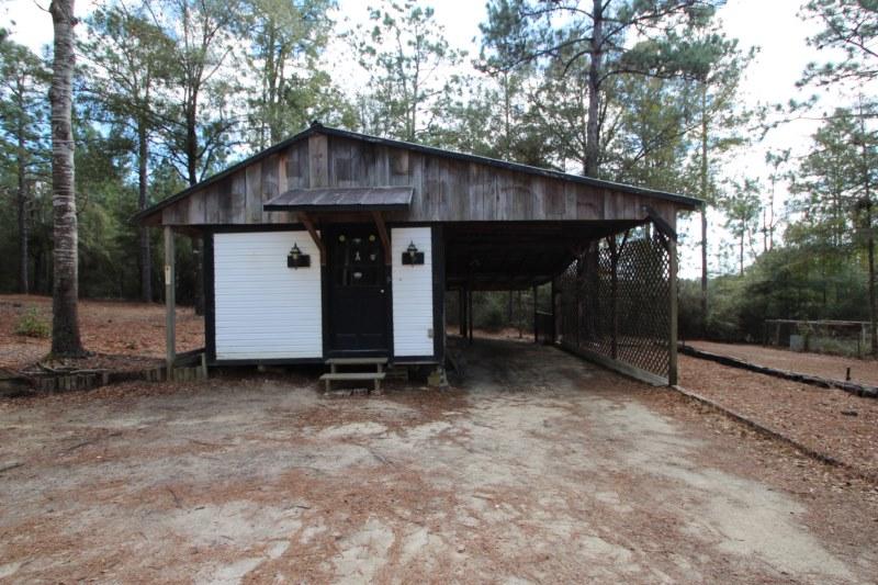 6019 Gagnon Road Crestview, FL 32539 - Photo 9 of 36 a view of backyard with wooden fence and a large tree