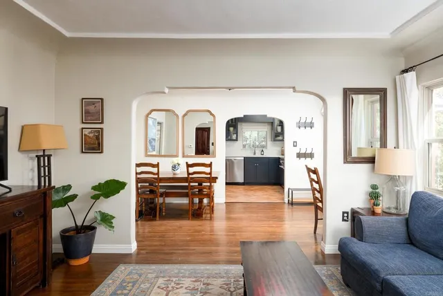 a view of a dining room with furniture and wooden floor