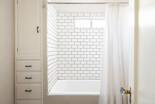 a bed room with a bed and a window