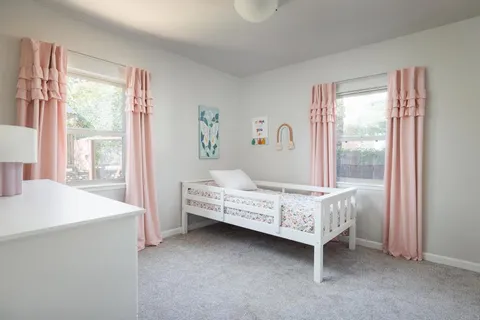 a bedroom with a bed and a dresser in it