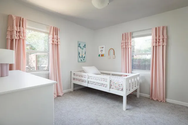 a bedroom with a bed and a dresser in it