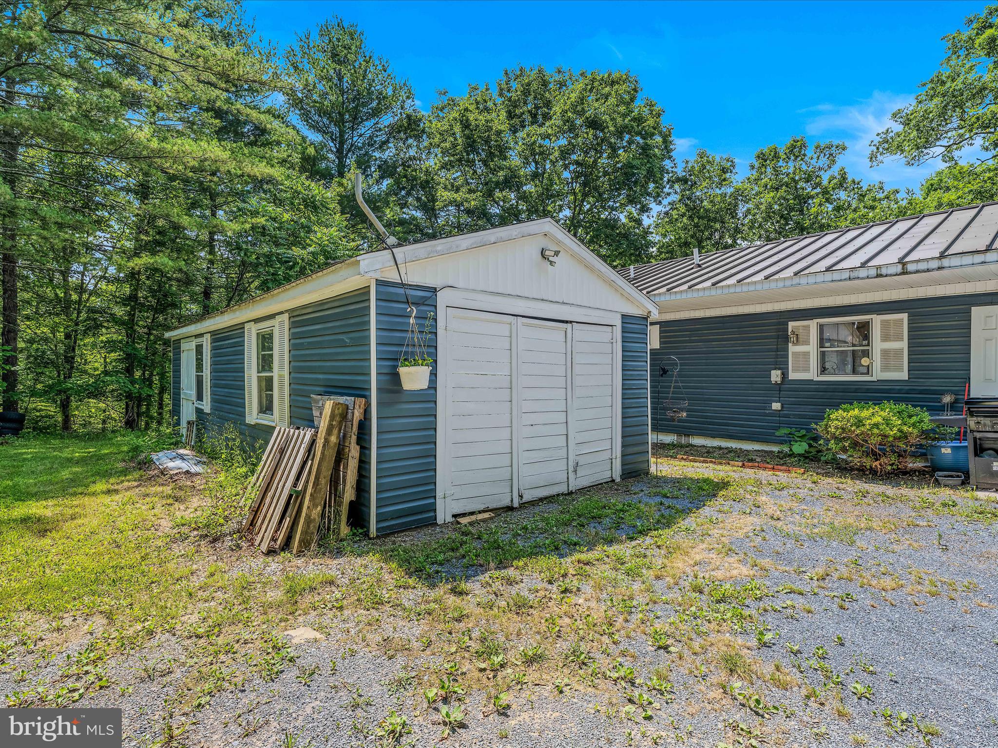 378 Oak Hill Road Berkeley Springs, WV 25411 - Photo 20 of 57 front view of a house with a yard