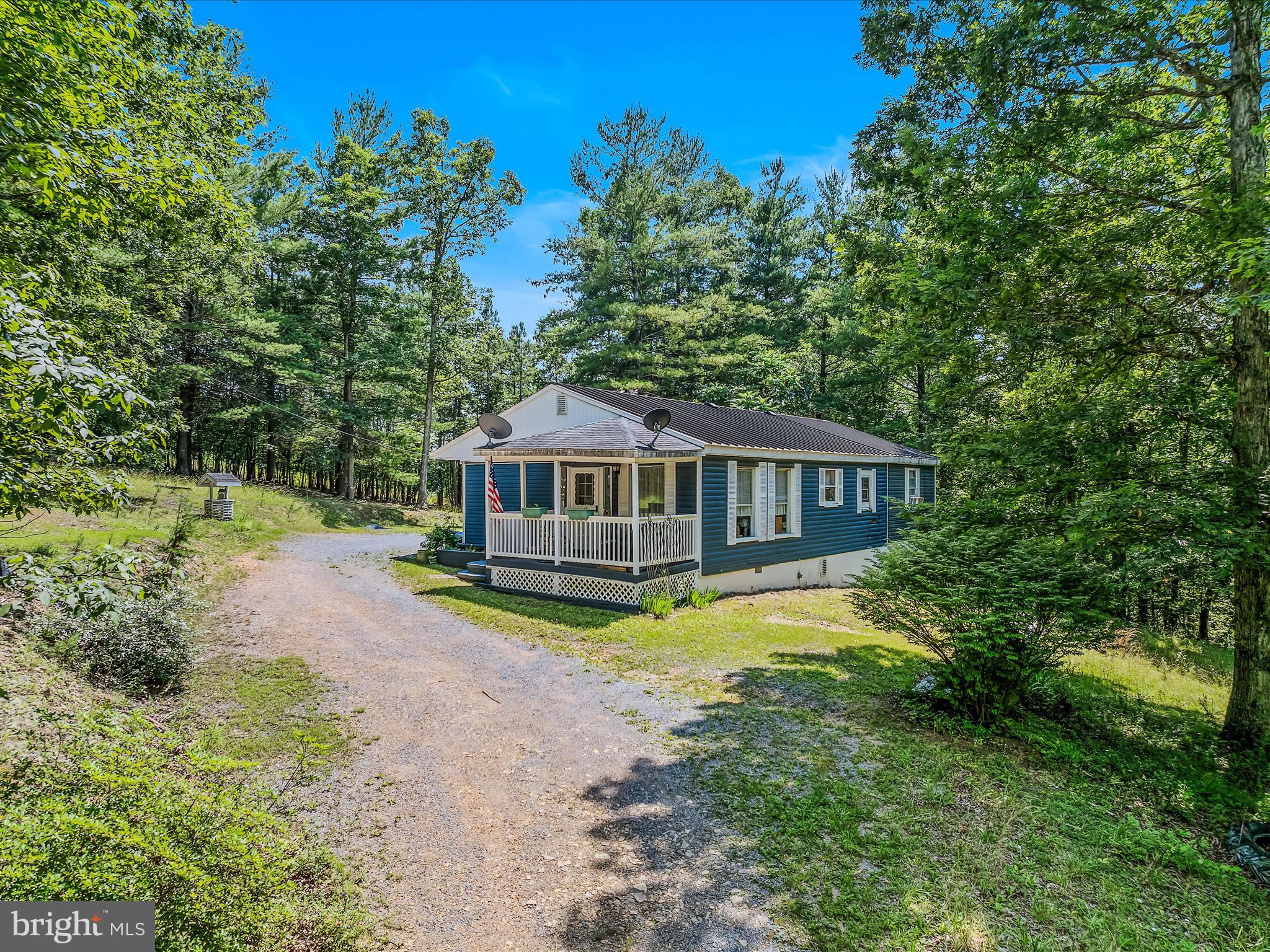 378 Oak Hill Road Berkeley Springs, WV 25411 - Photo 2 of 57 a view of a house with a yard