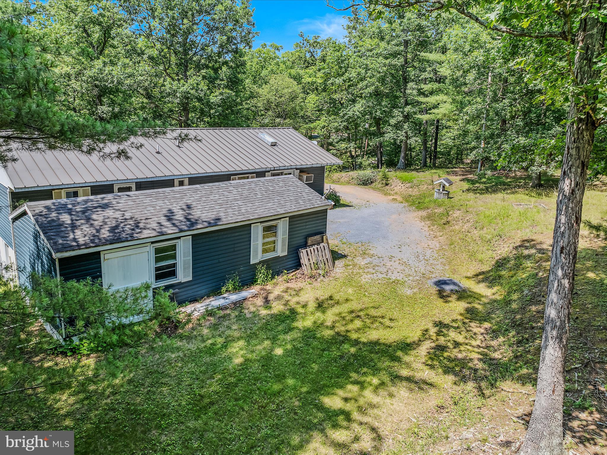 378 Oak Hill Road Berkeley Springs, WV 25411 - Photo 21 of 57 a backyard of a house with a yard and outdoor seating