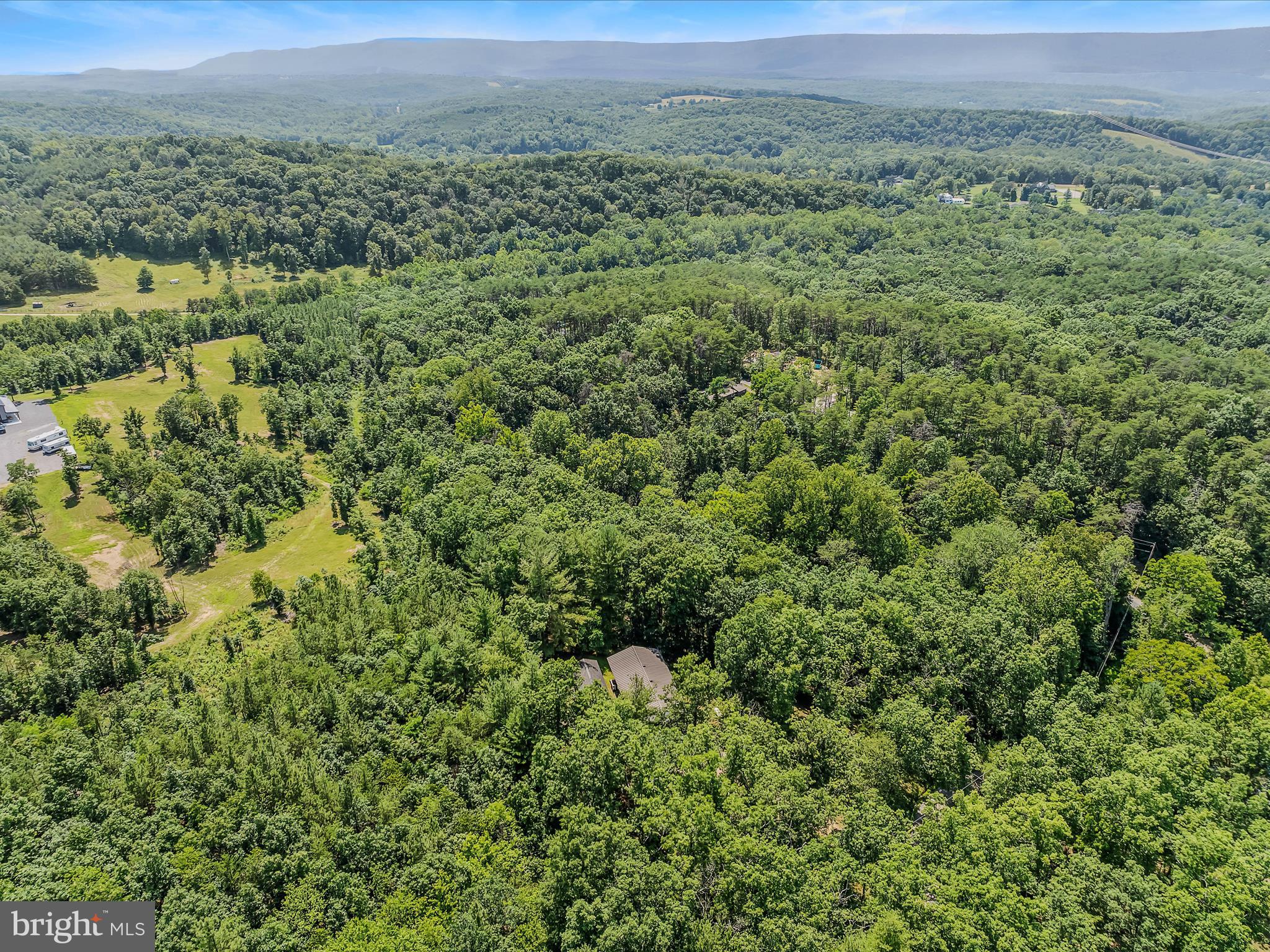 378 Oak Hill Road Berkeley Springs, WV 25411 - Photo 25 of 57 a view of a green field with lots of bushes