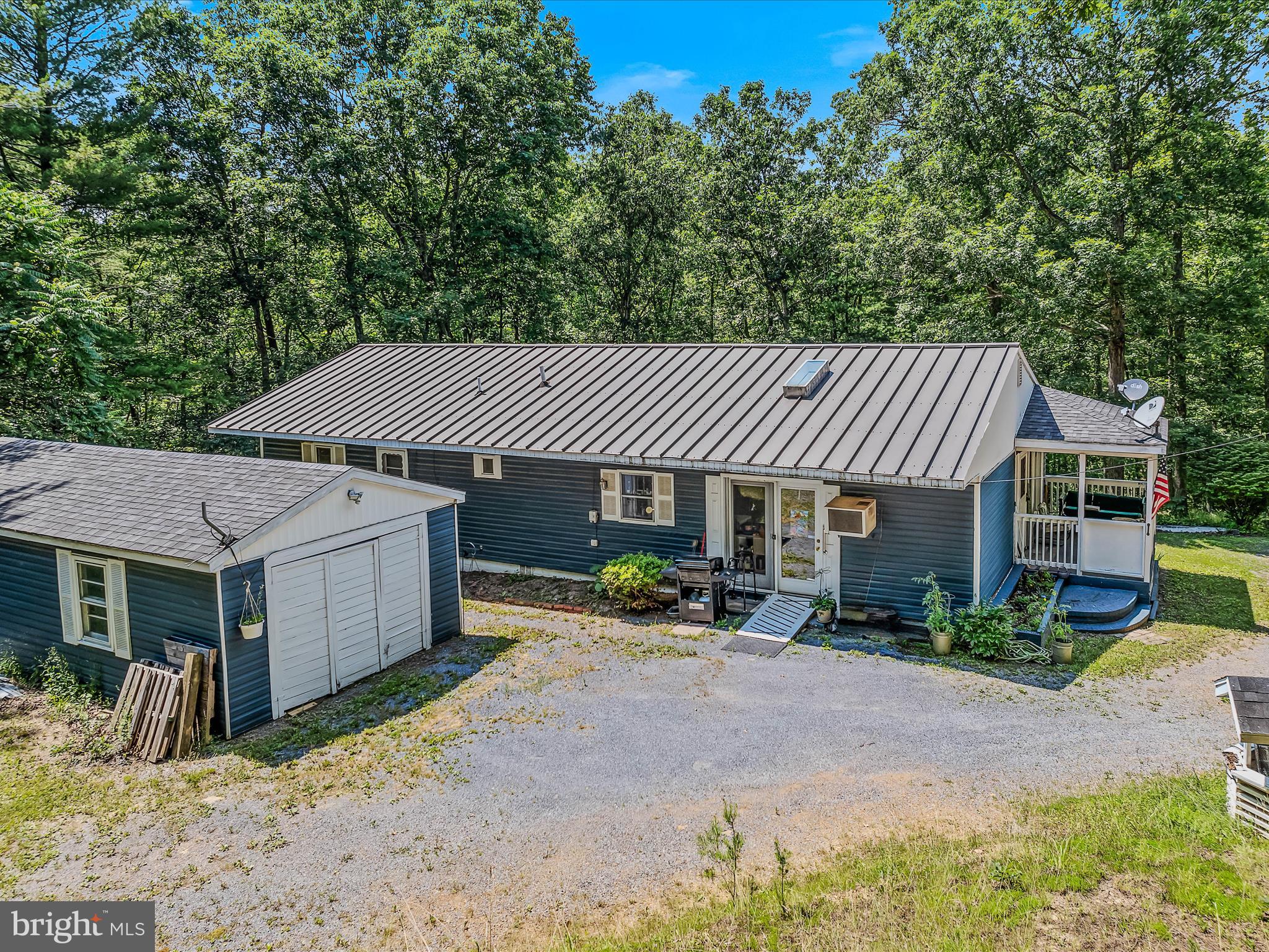 378 Oak Hill Road Berkeley Springs, WV 25411 - Photo 31 of 57 a view of a house with backyard and sitting area