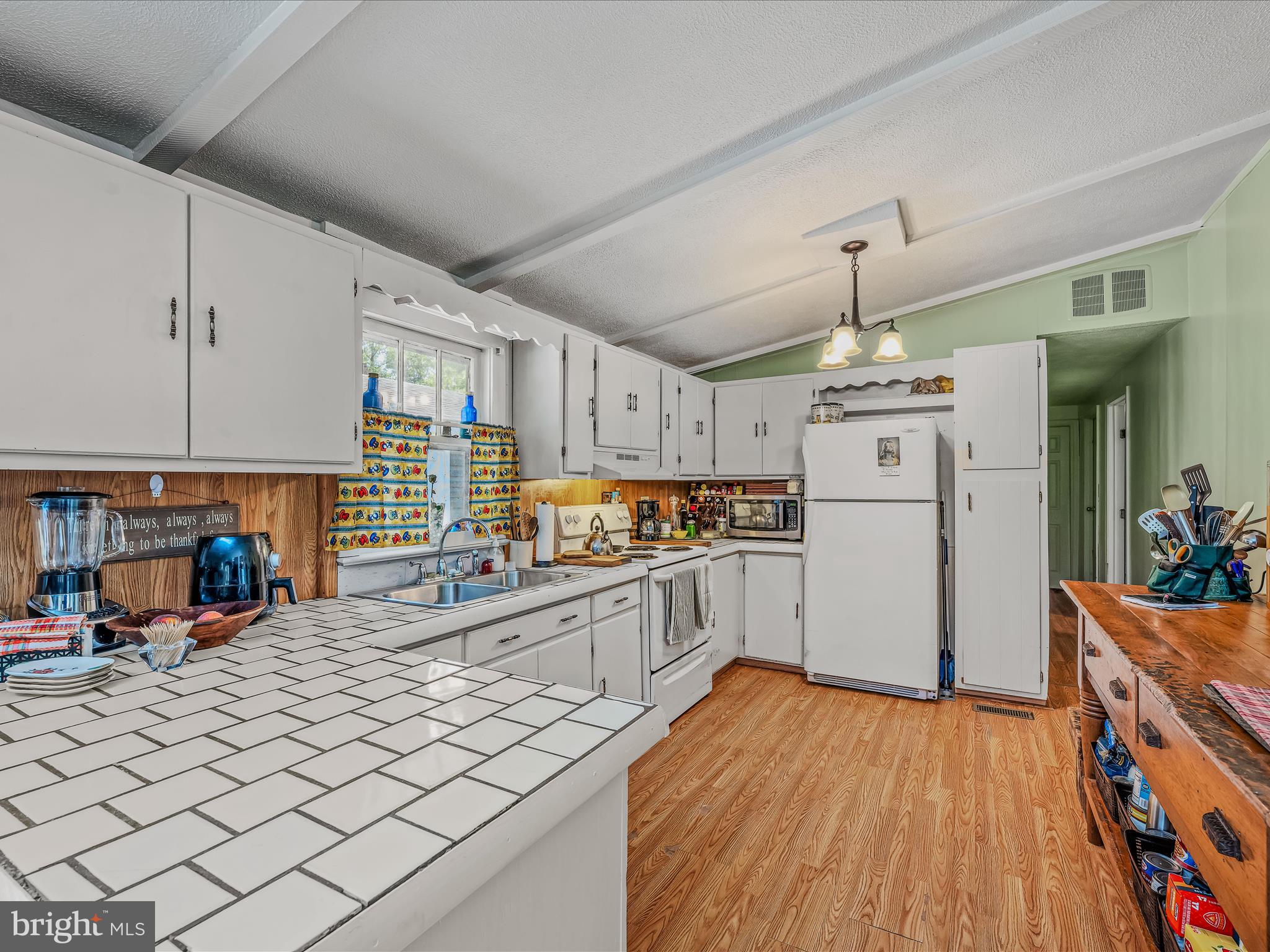 378 Oak Hill Road Berkeley Springs, WV 25411 - Photo 36 of 57 a kitchen with stainless steel appliances a refrigerator and a wooden floor