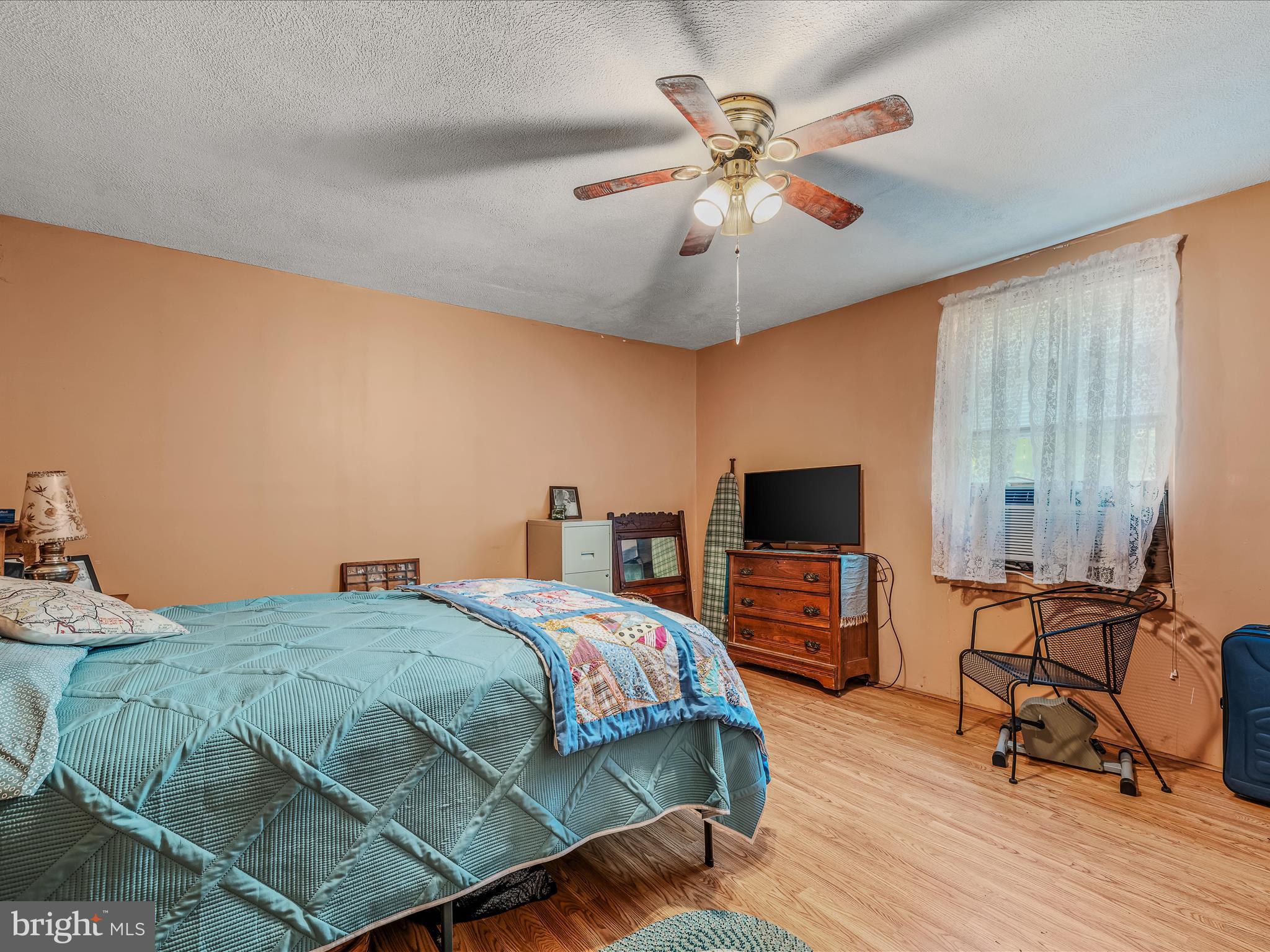 378 Oak Hill Road Berkeley Springs, WV 25411 - Photo 45 of 57 a bedroom with a bed and a flat screen tv