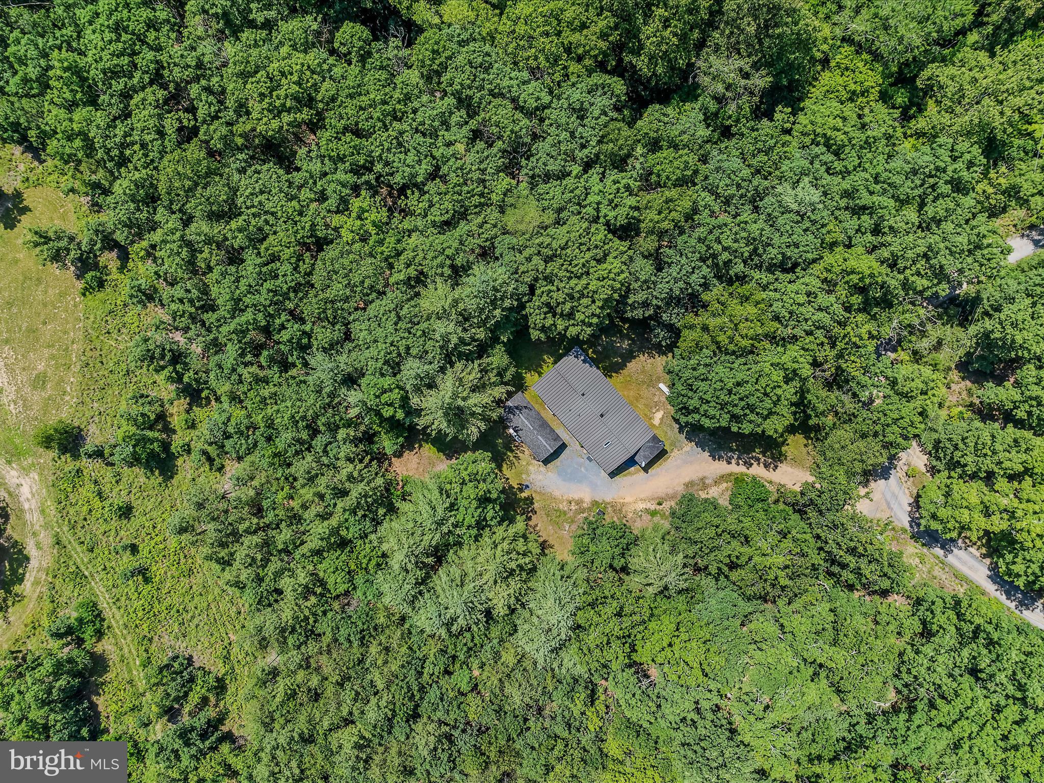 378 Oak Hill Road Berkeley Springs, WV 25411 - Photo 52 of 57 an aerial view of a house with a yard