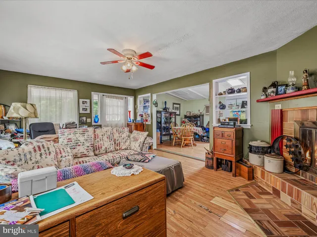 a living room with furniture a flat screen tv and a window
