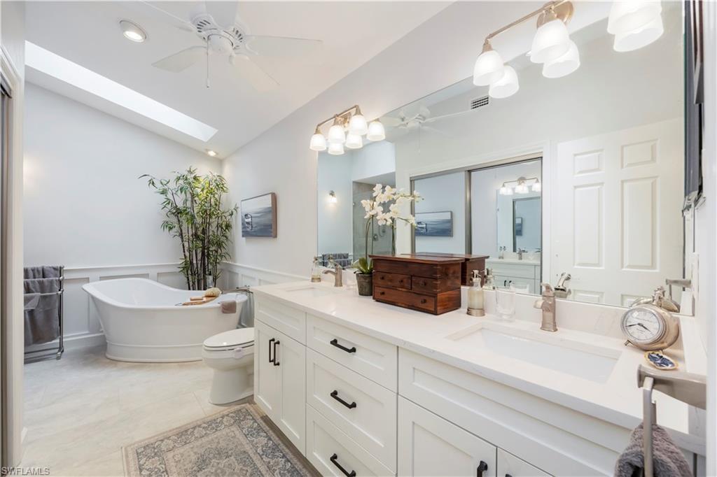 5520 Cynthia Lane Naples, FL 34112 - Photo 11 of 32 a bathroom with a double vanity sink mirror and bathtub