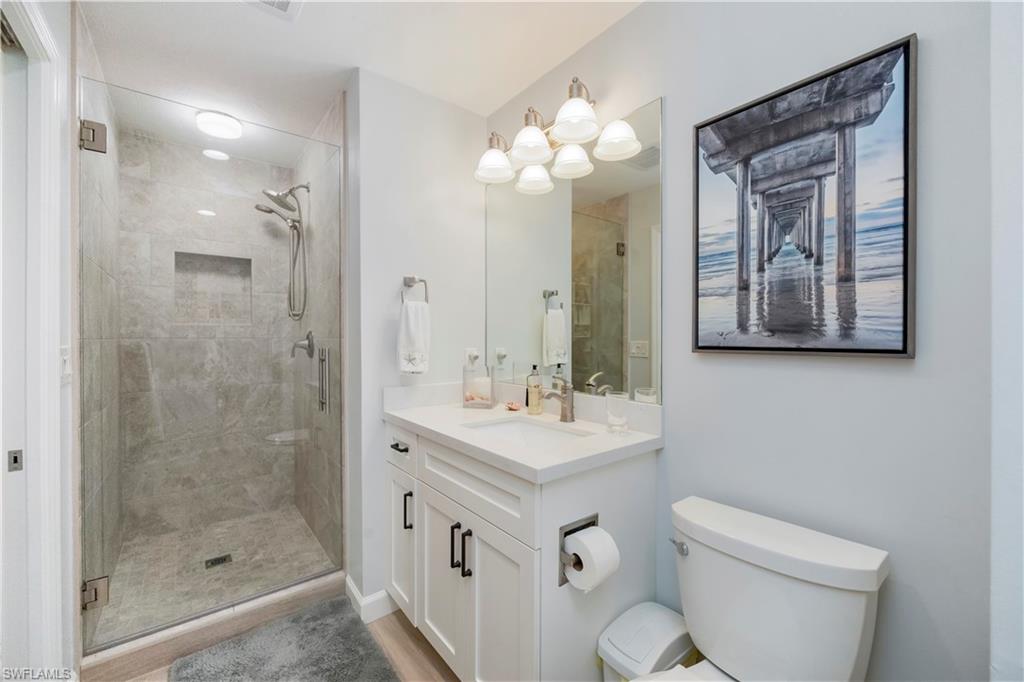 5520 Cynthia Lane Naples, FL 34112 - Photo 14 of 32 a bathroom with a sink a toilet and a mirror