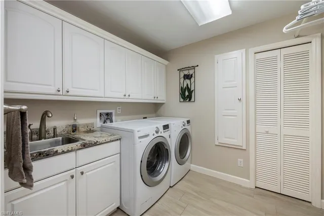a view of kitchen sink and cabinets with wooden floor