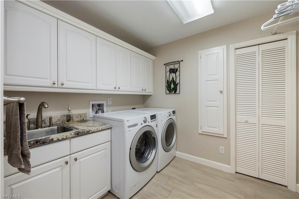 5520 Cynthia Lane Naples, FL 34112 - Photo 18 of 32 a view of kitchen sink and cabinets with wooden floor