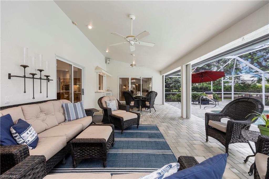5520 Cynthia Lane Naples, FL 34112 - Photo 19 of 32 a living room with furniture ceiling fan and a floor to ceiling window