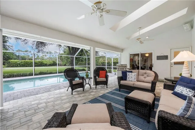 a living room with furniture and a floor to ceiling window