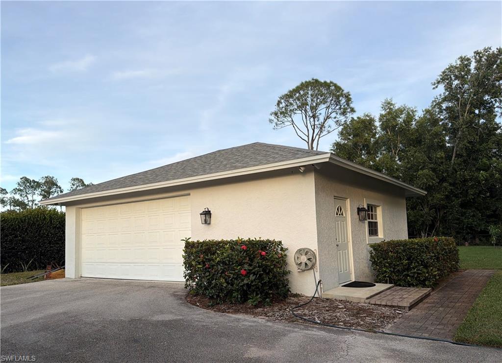 5520 Cynthia Lane Naples, FL 34112 - Photo 28 of 32 a front view of a house with garden