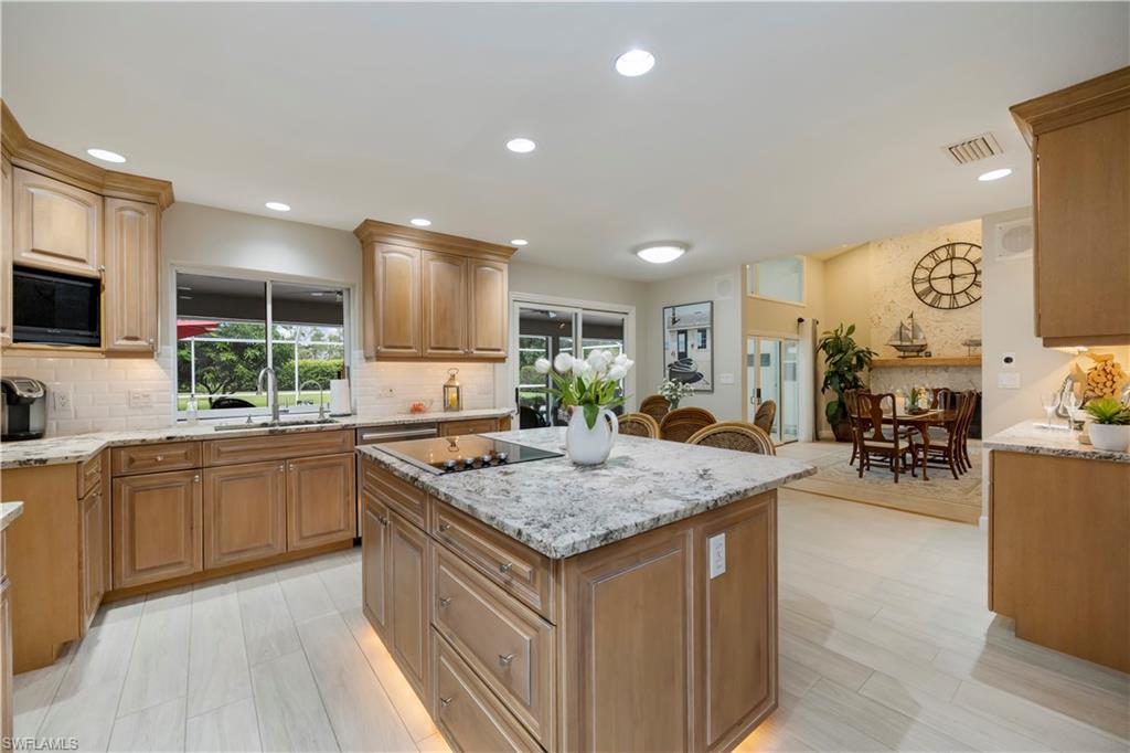 5520 Cynthia Lane Naples, FL 34112 - Photo 4 of 32 a kitchen with stainless steel appliances granite countertop sink stove top oven and cabinets