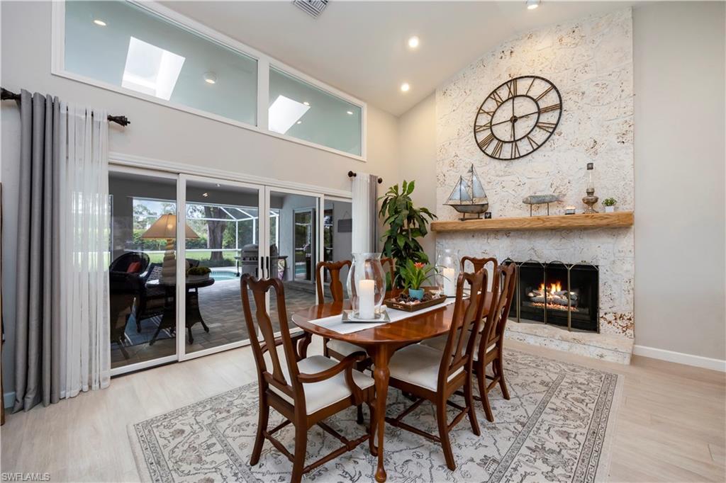 5520 Cynthia Lane Naples, FL 34112 - Photo 5 of 32 a dining room with furniture and a fireplace