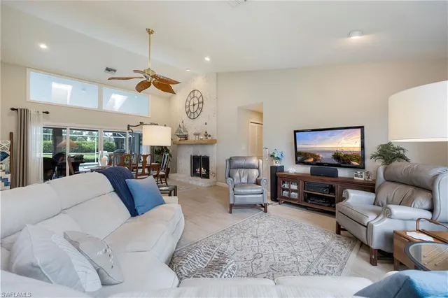 a living room with fireplace furniture and a flat screen tv