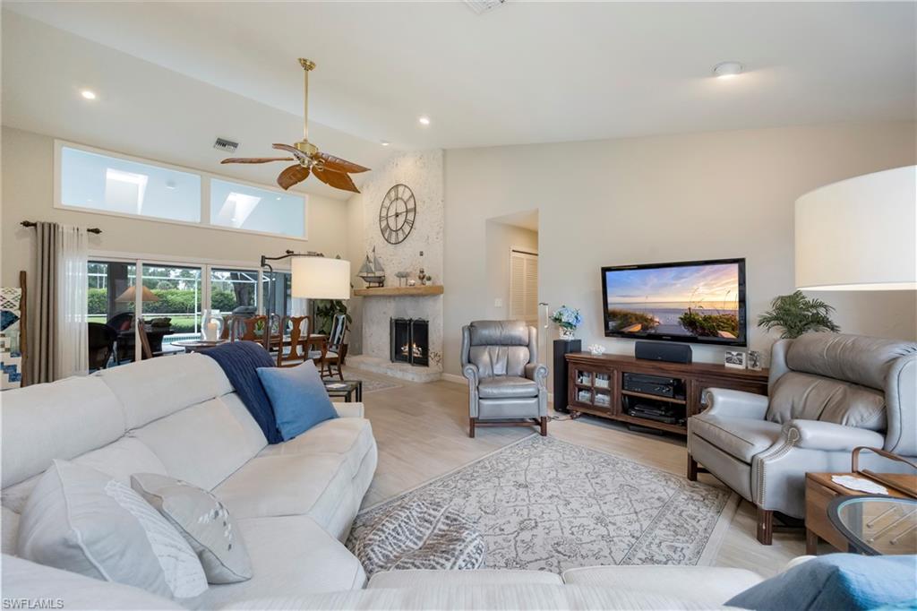 5520 Cynthia Lane Naples, FL 34112 - Photo 9 of 32 a living room with fireplace furniture and a flat screen tv