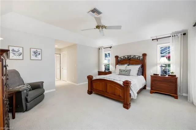 a bedroom with bed couch and window